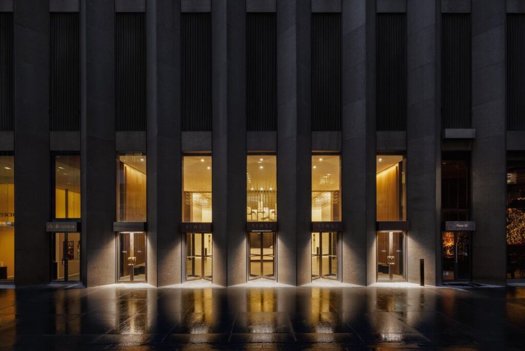 white sofa against a background of a black wall with molded white lighting